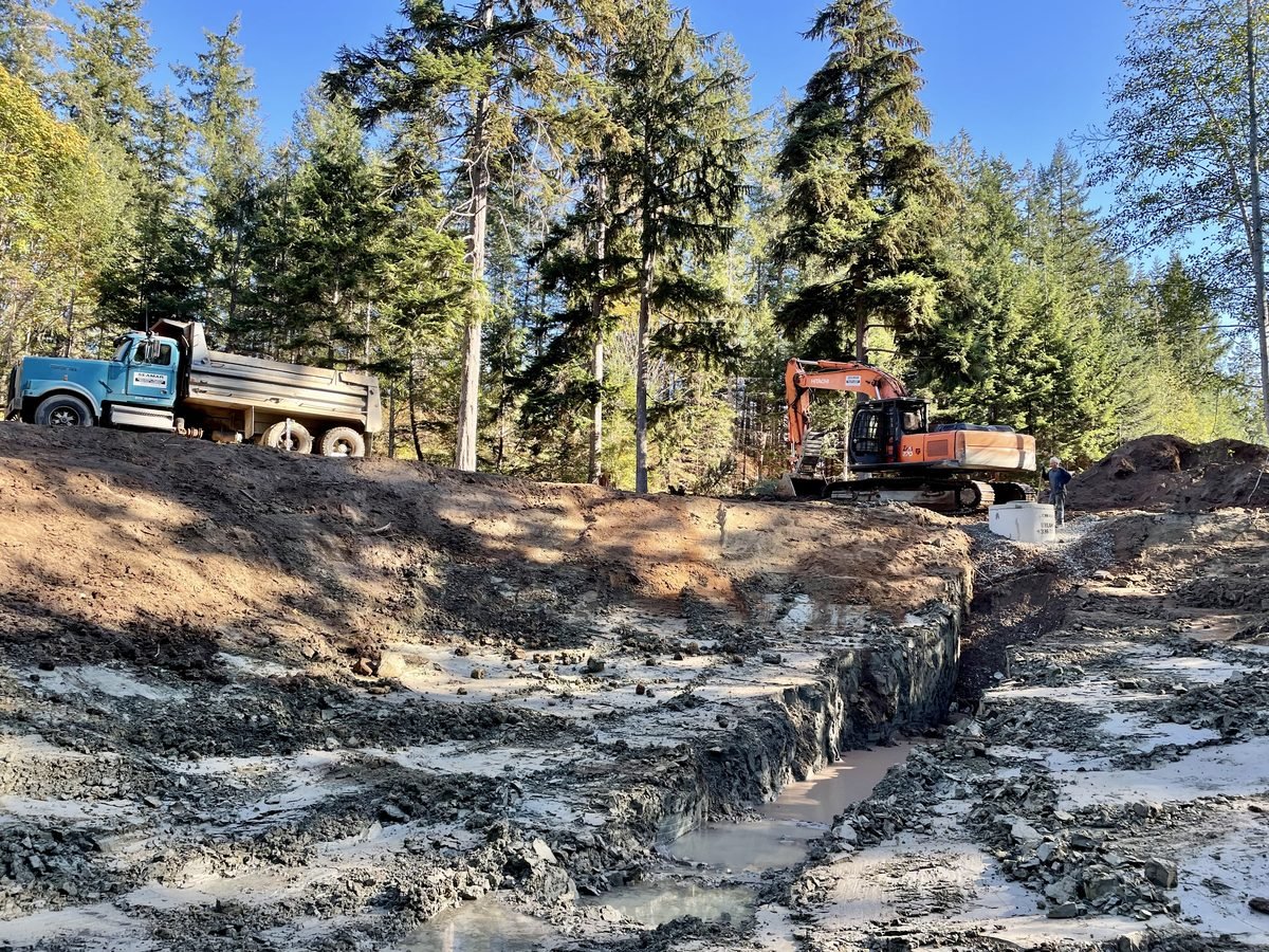 Dump truck and excavator on a Vancouver Island pond site